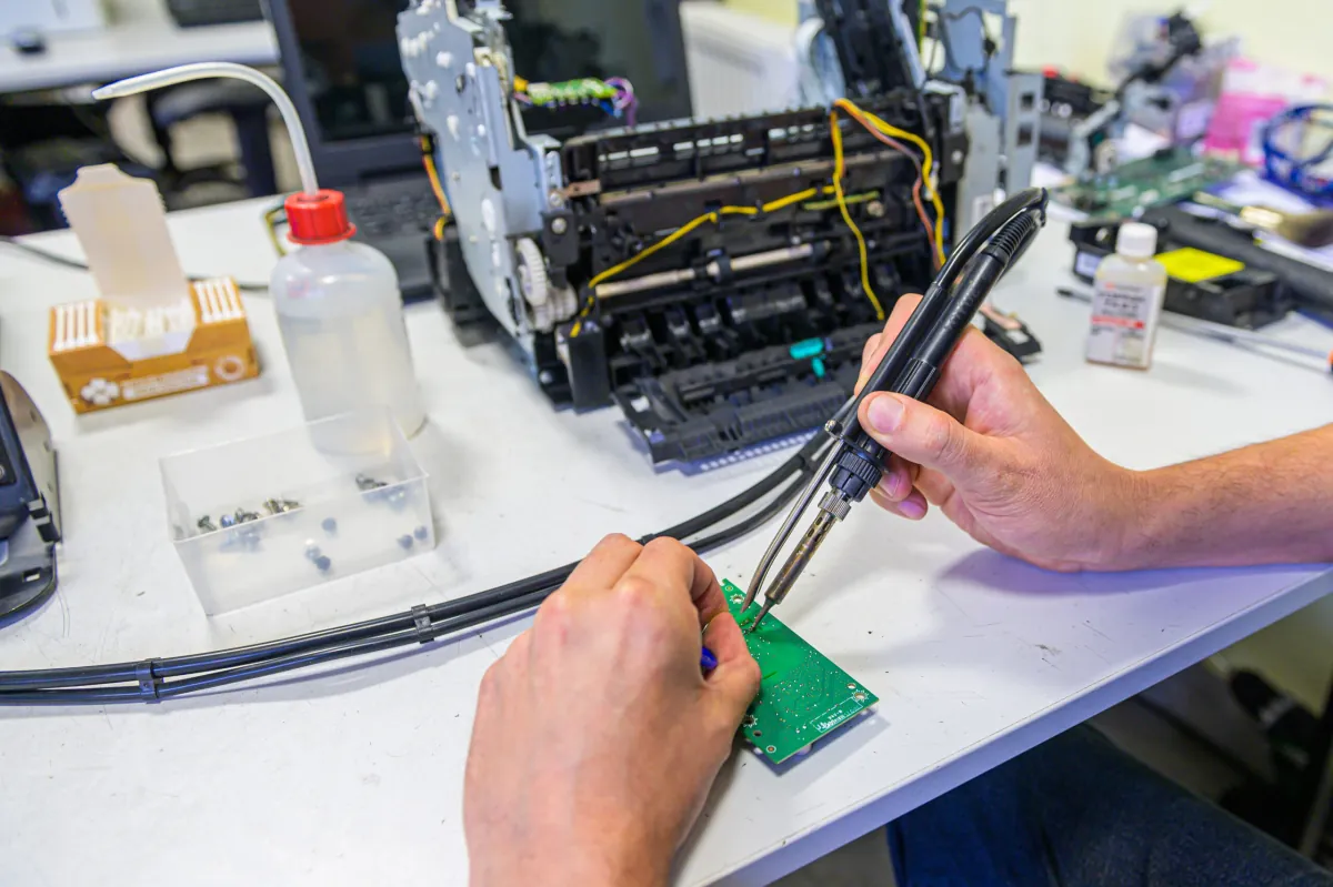 Technik serwisuje urządzenie wielofunkcyjne